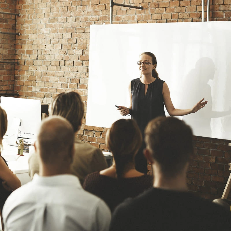 Woman presenting in front of an audience